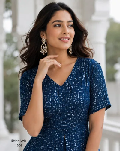 Georgette Sequins Embroidered Peplum Top with Shimmer Organza Lehenga.